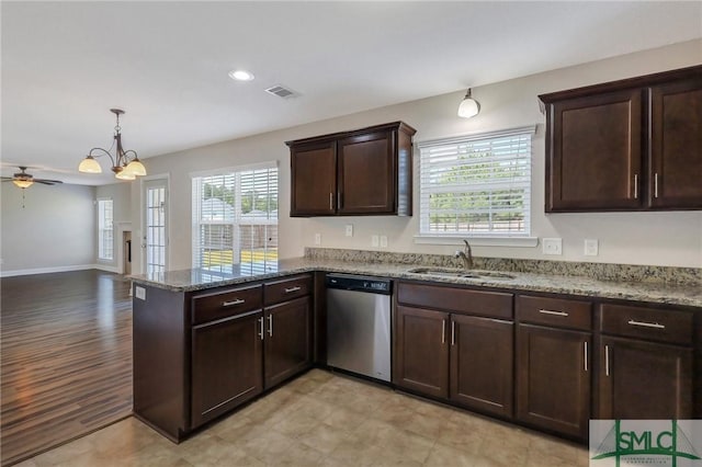 kitchen featuring stainless steel dishwasher, a sink, visible vents, and a wealth of natural light