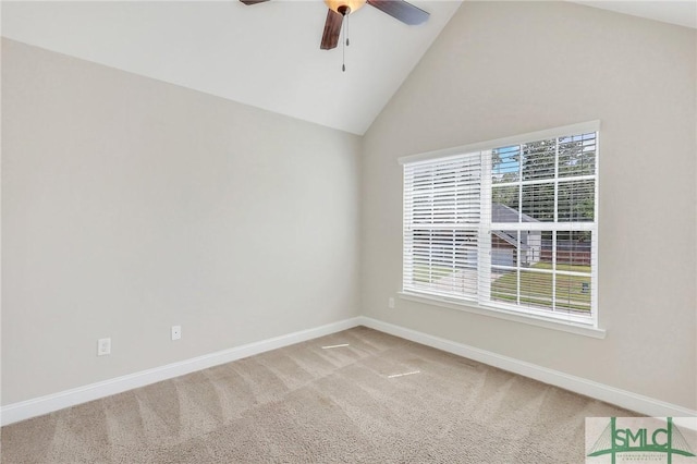 empty room featuring a ceiling fan, baseboards, vaulted ceiling, and carpet