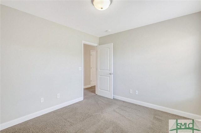 carpeted empty room with baseboards