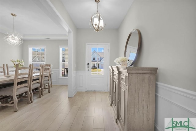130 Canter Ct, Savannah, GA 31406 - foyer featuring a chandelier, wainscoting, light wood-style flooring, and a decorative wall