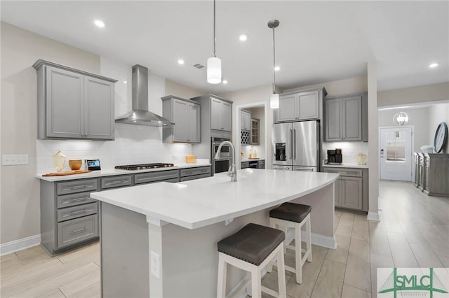 130 Canter Ct, Savannah, GA 31406 - kitchen with appliances with stainless steel finishes, gray cabinetry, wall chimney range hood, and recessed lighting