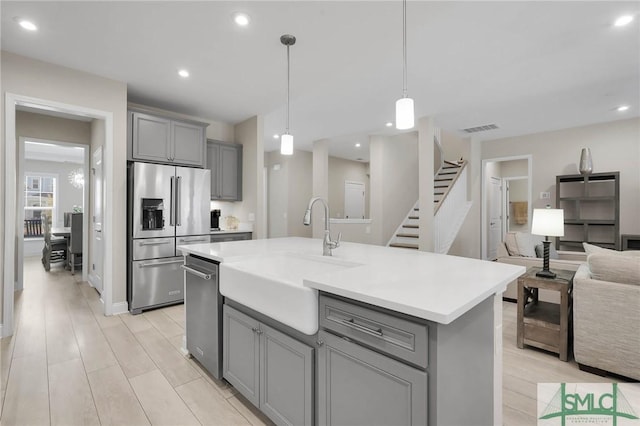 130 Canter Ct, Savannah, GA 31406 - kitchen with gray cabinetry, stainless steel appliances, a sink, open floor plan, and light countertops