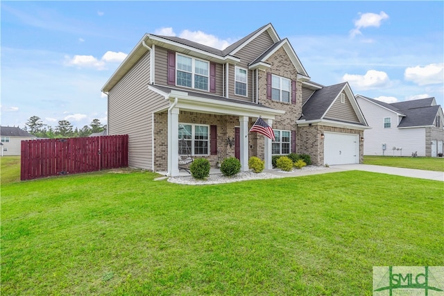 craftsman inspired home featuring a front lawn, fence, brick siding, a porch, and driveway