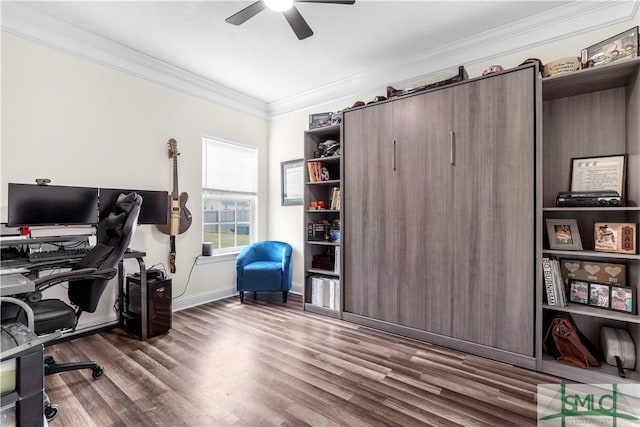 home office featuring crown molding, baseboards, ceiling fan, and wood finished floors
