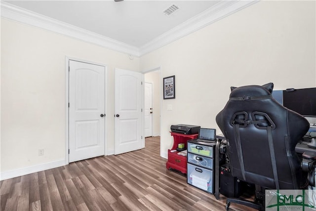 home office featuring crown molding, baseboards, visible vents, and wood finished floors