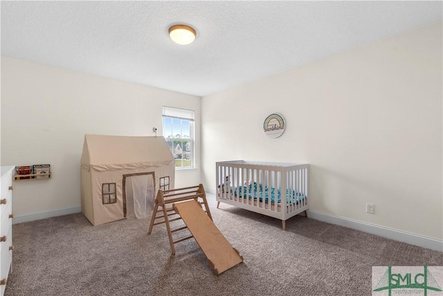 bedroom featuring a textured ceiling, baseboards, and carpet