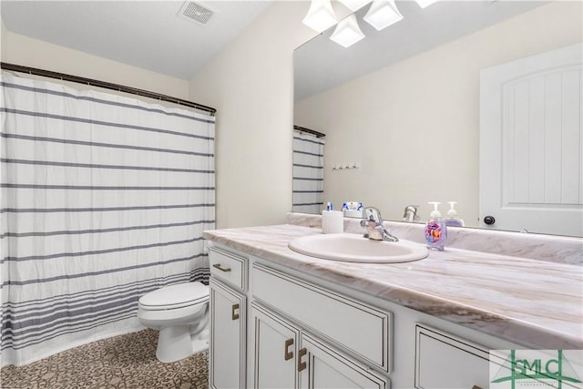 full bath with visible vents, vanity, toilet, a shower with shower curtain, and a skylight