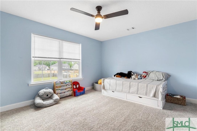 carpeted bedroom featuring baseboards, ceiling fan, and visible vents