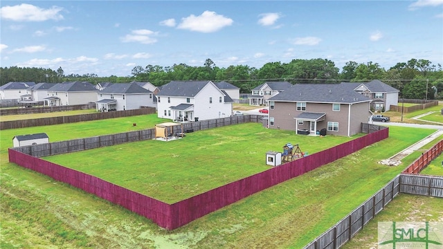 view of yard with a fenced backyard and a residential view