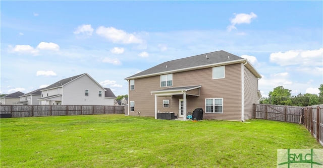 rear view of property featuring a lawn, central AC, a fenced backyard, and a patio area