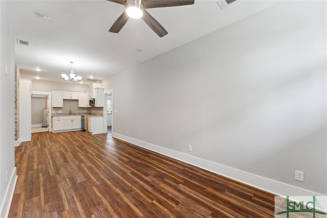 537 E Congress St, Savannah, GA 31401 - unfurnished living room featuring baseboards, visible vents, dark wood finished floors, and ceiling fan with notable chandelier