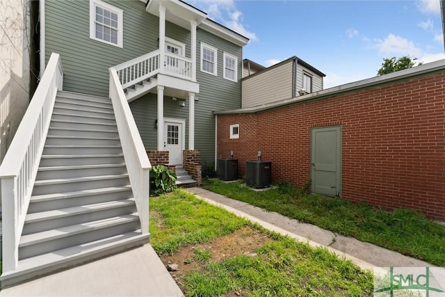 537 E Congress St, Savannah, GA 31401 - back of house with central air condition unit, stairway, and brick siding