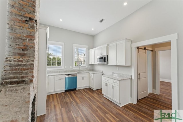 537 E Congress St, Savannah, GA 31401 - kitchen with visible vents, dark wood-style flooring, dishwashing machine, white cabinetry, and stainless steel microwave