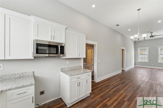 537 E Congress St, Savannah, GA 31401 - kitchen featuring white cabinets, dark wood-style flooring, a chandelier, stainless steel microwave, and open floor plan