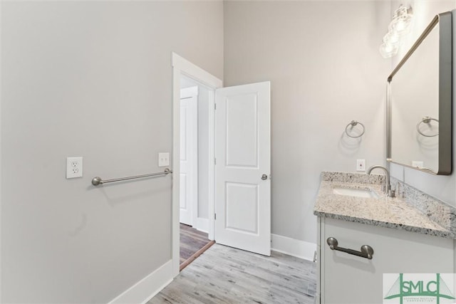 537 E Congress St, Savannah, GA 31401 - bathroom with vanity, baseboards, and wood finished floors