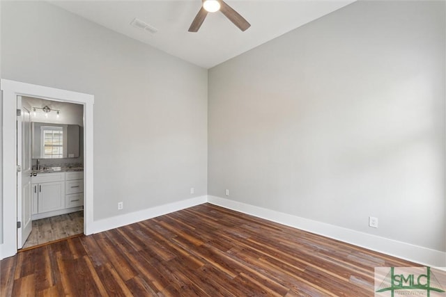 537 E Congress St, Savannah, GA 31401 - unfurnished bedroom with visible vents, baseboards, ceiling fan, connected bathroom, and dark wood finished floors