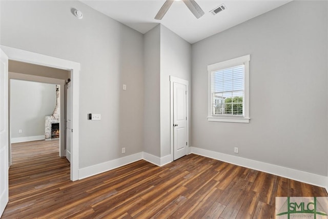 537 E Congress St, Savannah, GA 31401 - unfurnished bedroom with ceiling fan, baseboards, visible vents, and dark wood finished floors