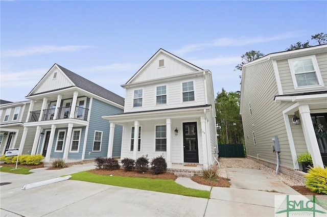 view of front of home featuring fence, board and batten siding, a porch, and a balcony