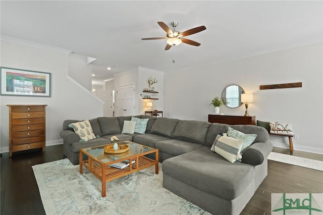 living area with baseboards, ceiling fan, ornamental molding, and wood finished floors
