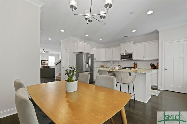 dining room featuring recessed lighting, crown molding, stairs, and dark wood-style flooring