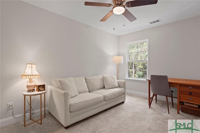 living area featuring visible vents, baseboards, ceiling fan, and light carpet