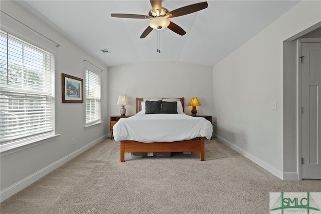 bedroom with visible vents, light carpet, baseboards, ceiling fan, and vaulted ceiling