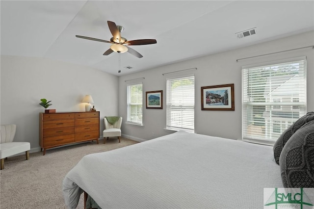bedroom with a ceiling fan, light colored carpet, visible vents, and lofted ceiling
