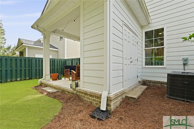 view of side of home featuring central air condition unit and fence