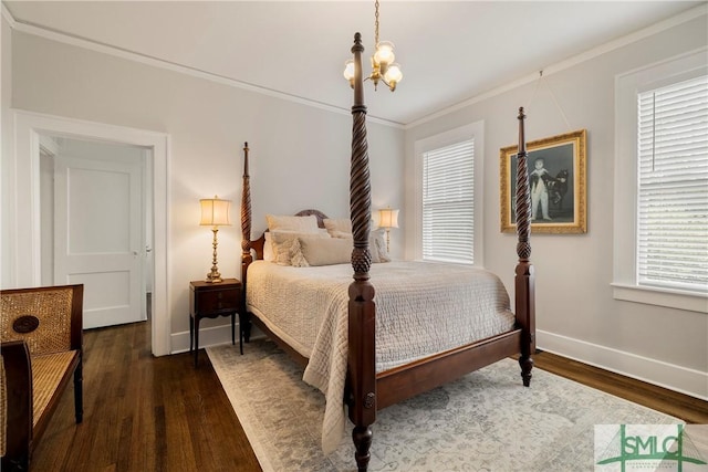 bedroom featuring baseboards, an inviting chandelier, ornamental molding, and wood finished floors