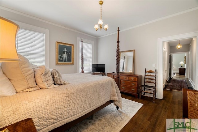 bedroom featuring an inviting chandelier, ornamental molding, and wood finished floors