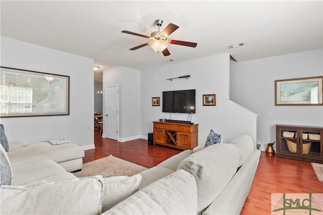 living area with visible vents, ceiling fan, and wood finished floors