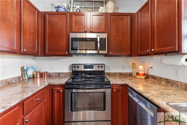 kitchen featuring reddish brown cabinets, backsplash, and stainless steel appliances