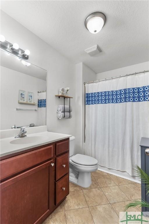 full bath with visible vents, vanity, curtained shower, toilet, and tile patterned floors