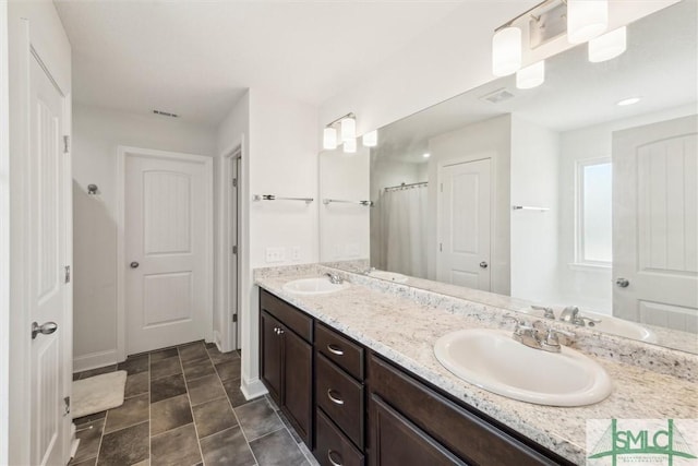 4 Rimes Ave SE, Ludowici, GA 31316 - full bath featuring double vanity, baseboards, visible vents, and a sink
