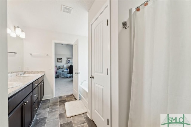 4 Rimes Ave SE, Ludowici, GA 31316 - full bathroom featuring double vanity, a garden tub, visible vents, a sink, and connected bathroom