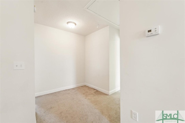 4 Rimes Ave SE, Ludowici, GA 31316 - spare room featuring baseboards, carpet, and attic access
