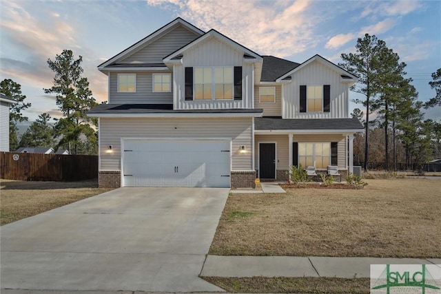 4 Rimes Ave SE, Ludowici, GA 31316 - view of front of house featuring fence, covered porch, brick siding, an attached garage, and driveway