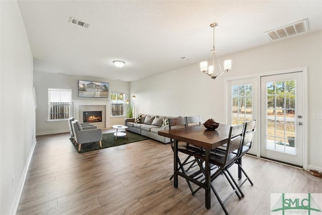 4 Rimes Ave SE, Ludowici, GA 31316 - dining space with baseboards, visible vents, an inviting chandelier, and light wood-type flooring