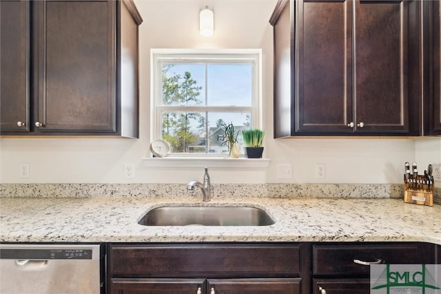 4 Rimes Ave SE, Ludowici, GA 31316 - kitchen with stainless steel dishwasher, a sink, light stone counters, and dark brown cabinets