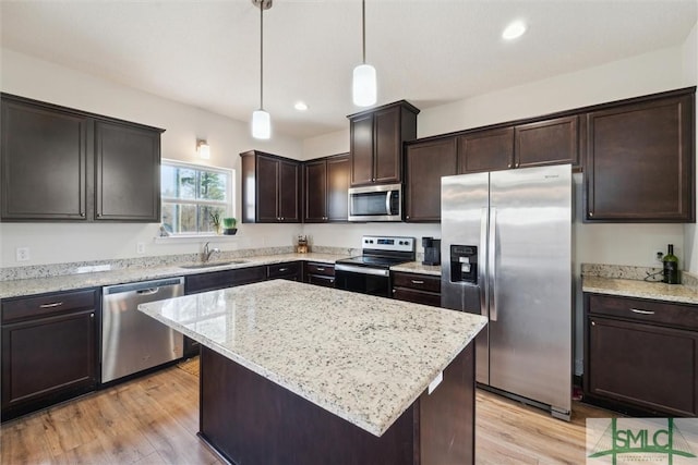 4 Rimes Ave SE, Ludowici, GA 31316 - kitchen featuring pendant lighting, dark brown cabinetry, light wood-style floors, a sink, and stainless steel appliances