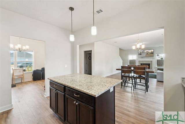 4 Rimes Ave SE, Ludowici, GA 31316 - kitchen featuring visible vents, open floor plan, a notable chandelier, and a healthy amount of sunlight