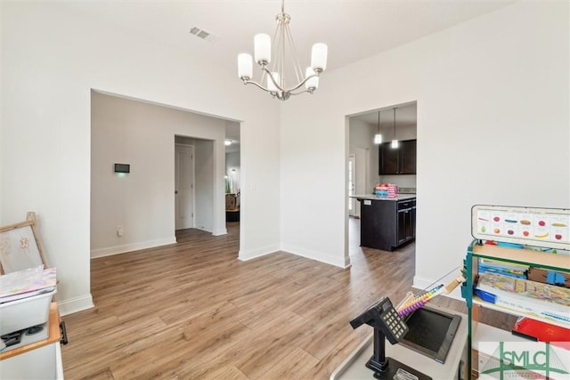 4 Rimes Ave SE, Ludowici, GA 31316 - interior space featuring baseboards, a notable chandelier, visible vents, and light wood-style flooring