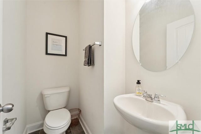 4 Rimes Ave SE, Ludowici, GA 31316 - bathroom with toilet, baseboards, and a sink