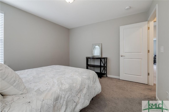 bedroom featuring baseboards and carpet