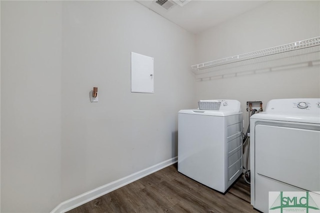 washroom featuring laundry area, baseboards, dark wood-type flooring, washer and clothes dryer, and electric panel