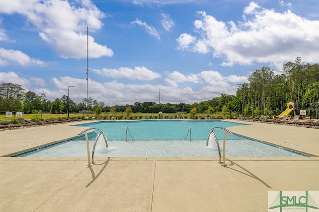 pool featuring a patio area and fence