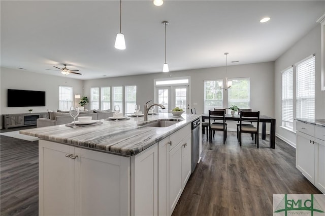 kitchen featuring a ceiling fan, white cabinets, a sink, dark wood finished floors, and dishwasher