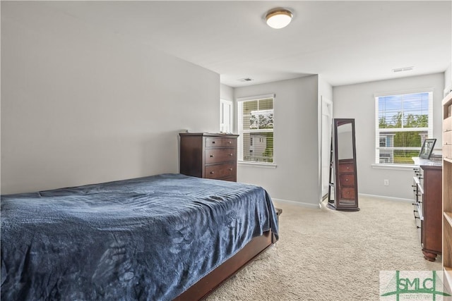 227 Flagler Dr, Savannah, GA 31419 - bedroom with baseboards, light colored carpet, multiple windows, and visible vents