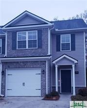 traditional home featuring an attached garage and concrete driveway