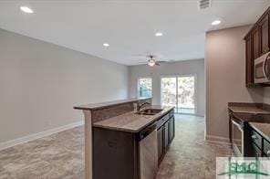 kitchen with recessed lighting, appliances with stainless steel finishes, a sink, and dark brown cabinets